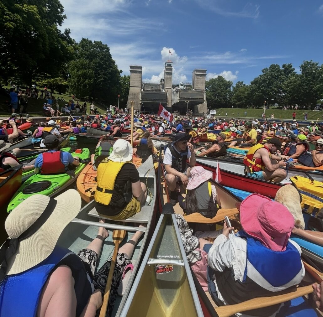 A group of paddles at the Peterborough lift lock paddle event in front of the lift lock on the Trent.