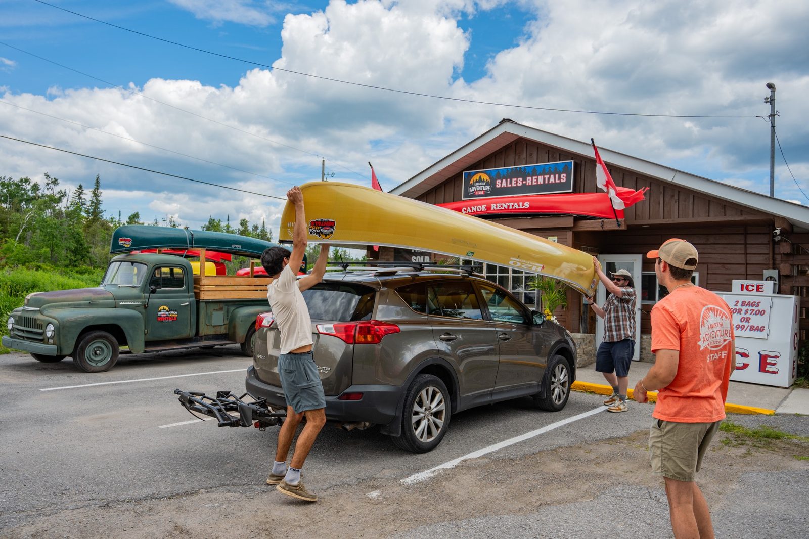 Customers loading a lightweight canoe at Kawartha Adventure Rentals before a backcountry canoe trip in Kawartha Highlands Provincial Park.